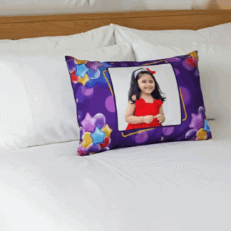 Personalized birthday photo cushion featuring a child's portrait with colorful star design. Perfect.