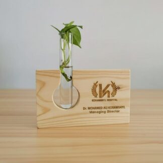 Custom engraved wooden test tube holder with plant for personalized gifts.