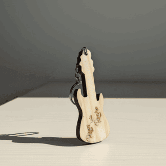 Personalized wooden guitar keyring with engraved text.
